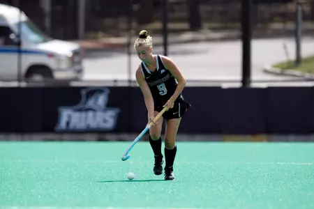 Field Hockey forward Allie Lancaster takes the ball up field during a game at Lennon Family Field.