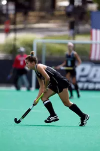 Field Hockey forward Megan Hamilton has possession of the ball while she looks up field during a game at Lennon Family Field.