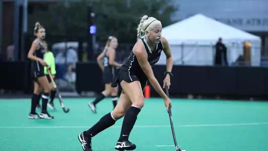 Field Hockey forward Madison Deeds has possession of the ball while she looks up field for an open pass during a game at Lennon Family Field.