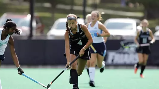 Field Hockey forward Izzy Mendez dribbles upfield as a Maine defender attempts to steal the ball at Lennon Family Field.