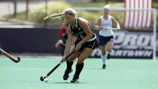 Field Hockey midfielder Allyson Parker takes the ball up field during a game at Lennon Family Field.