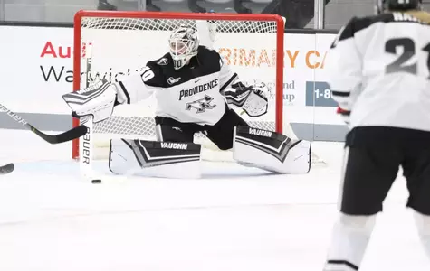 Women's ice hockey goalie Sandra Abstreiter making a stick save during a game