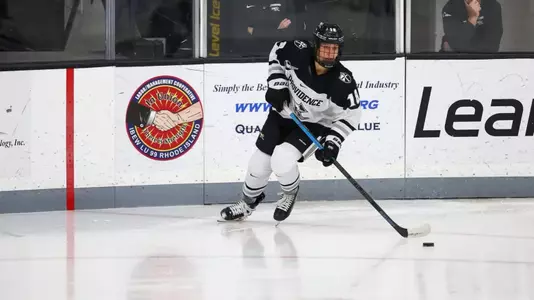 Women's ice hockey player Ariane Julien skating with the puck during a game