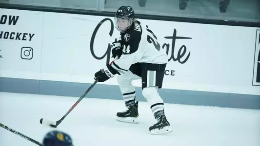 Women's ice hockey player Hayley Lunny skating with the puck during a game