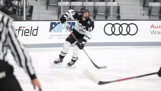 Women's ice hockey player Sara Hjalmarsson skating with the puck during a game