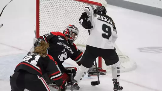 A photo of women's ice hockey player Meaghan Rickard scoring a goal during a game against Northeastern