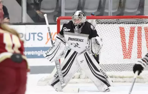 A photo of women's ice hockey goalie Madison Myers preparing to make a save during a game