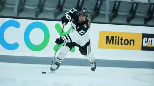 Women's ice hockey player Avery Fransoo taking a shot during a game