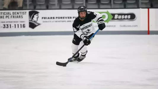 Women's ice hockey player Sonja Bjornson skating with the puck during a game