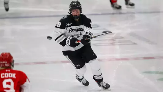 Women's ice hockey player Sara Hjalmarsson skating after the puck during a game