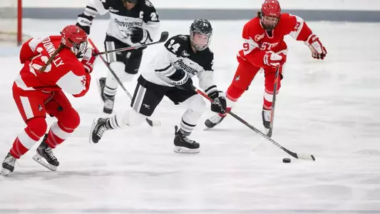 Women's ice hockey player Hayley Lunny skating with the puck during a game