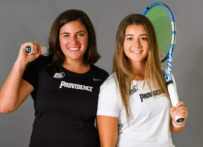 Tennis players Haley Gurski and Aiden Epstein pose with their rackets over their shoulders.