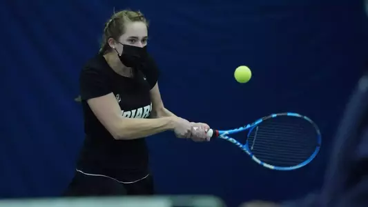 Tennis player Katie Mulvey hitting the ball forehand during a 2021 tennis match.