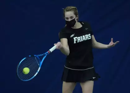 Tennis player Katie Mulvey hitting the ball forehand during a 2021 indoor match.