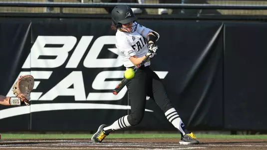 Rachael Petrarca in the middle of hitting during a softball game in 2022.