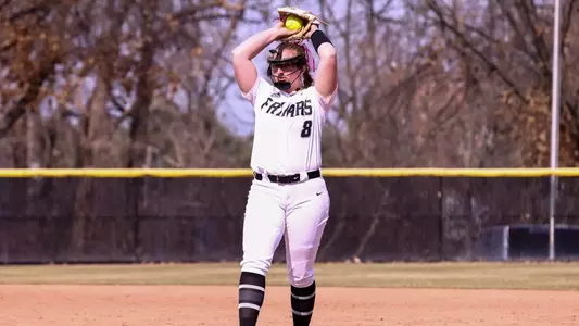 Tori Grifone getting ready to throw her next pitch in a softball game.