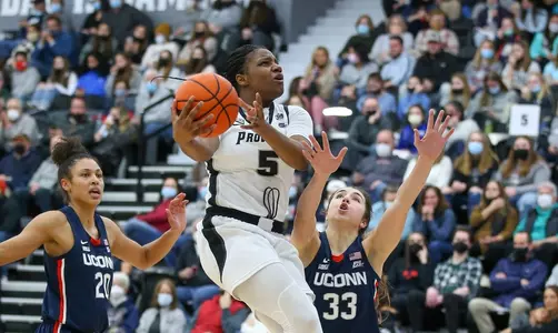 Janai Crooms elevates for a lay-up against UConn during a match-up in 2021-22 season at Alumni Hall