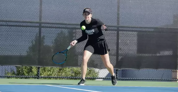 Tennis player Lauren Carson hits the ball during a 2023 outdoor match.