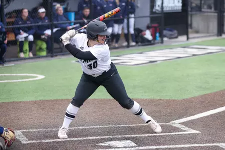 Julia Renny hitting in softball game