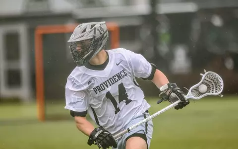 Dean Metzger cradles the ball in 2023 rain game against Marquette.