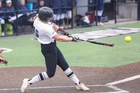 Jacque Harrington hitting in softball game.