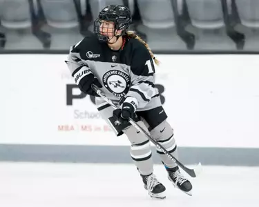 Women's Ice Hockey forward Dylan Berman shown looking to be an open pass during gameplay at Schneider Arena.