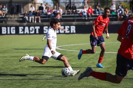 Gabriel Chavez men's soccer running with soccer ball action shot