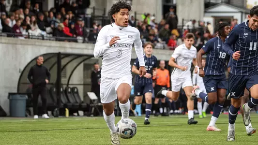 Gabriel Chavez running with soccer ball action shot