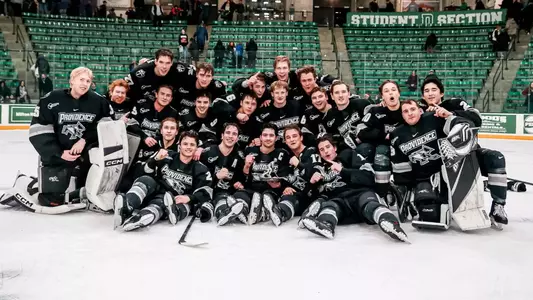 Providence College Men's Ice Hockey group photo on the ice after win against Northeastern in Ledyard Classic