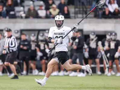 Ian Olenik preparing for incoming pass as he runs down Chapey Field in Anderson Stadium in 2024 home game.