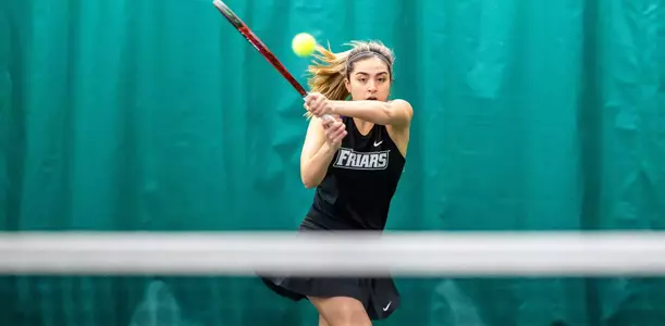 Tennis player Erika Beltran follows through on her swing during a 2024 indoor tennis match.