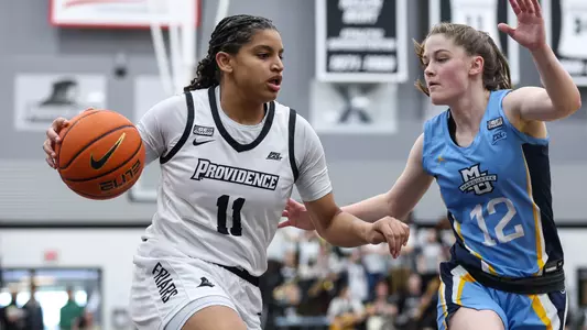 Nariah Scott dribbles to the basketball vs. Marquette in a women's basketball game