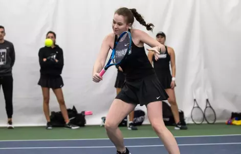 Tennis player Lauren Carson hits the ball backhand during a 2024 indoor match.