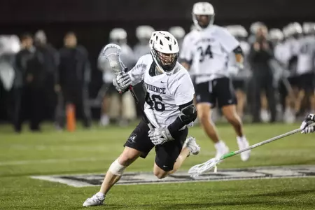 Tom Fegley cradling ball towards the goal in 2024 game