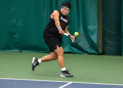 Tennis player Liria Loria hits the ball backhand during a 2024 indoor match.