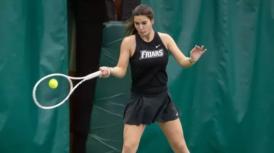Tennis player Camila Barrera hits the ball forehand during a 2024 indoor tennis match.