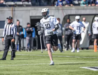 Tyler Flynn running into 2024 home game on Chapey Field in Anderson Stadium