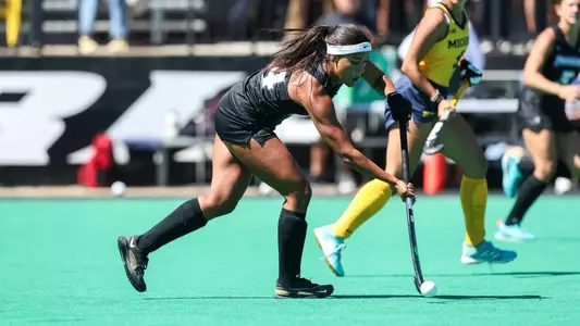 Field Hockey midfielder Bo Martina takes the ball upfield against Michigan at Lennon Family Field.