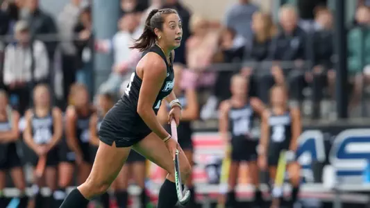 Field hockey midfielder Macie Pennisi is pictured during gameplay, looking upfield at Lennon Field.