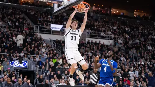 Men's Basketball player Ryan Mela dunking the ball against Seton Hall at the Amica Mutual Pavilion in 2025