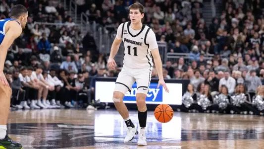 Men's Basketball player Ryan Mela handling the ball against Seton Hall at the Amica Mutual Pavilion in 2025