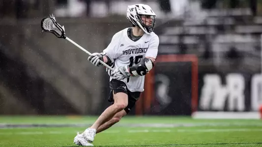 Ryan Bell cradling the ball preparing to make a play in 2024 home game on Chapey Field in Anderson Stadium