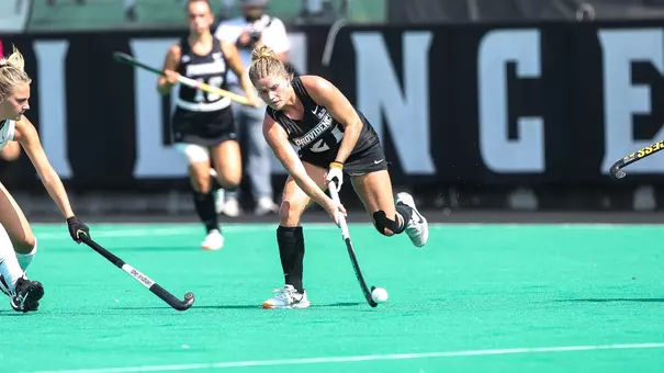Charlotte Lorden passes the ball to a teammate with her stick