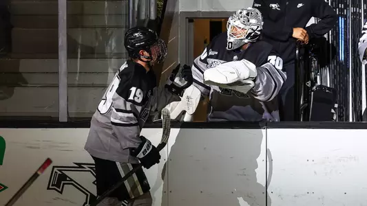 Tanner Adams and Jack Parsons celebrate a goal during a men's hockey game against Simon Fraser