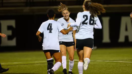 Lily Gibbs celebrates goal with Amaya Coffie and Ella McBride versus Marquette on Chapey Field at Anderson Stadium