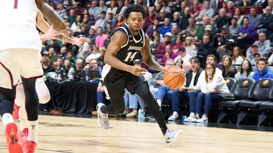 Corey Floyd driving with the basketball versus Virginia Tech at the Mohegan Sun.