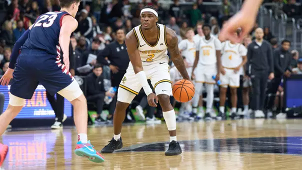 Jaylin Sellers dribbles the ball between his legs at the top of the key versus Penn at the Amica Mutual Pavilion.