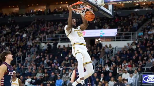 Oswin Erhunmwunse dunks the ball versus Penn at the Amica Mutual Pavilion.
