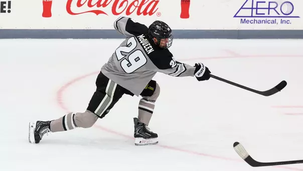 Men's Hockey's Roger McQueen taking a slap shot