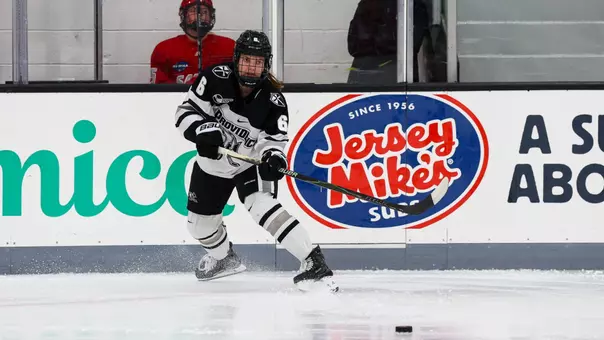 Women's ice hockey player Audrey Knapp making a pass during a game